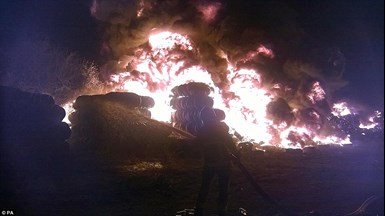 tyre fire with firefighter