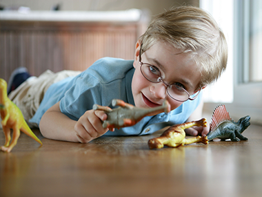 boy playing with old toys that could be recycled