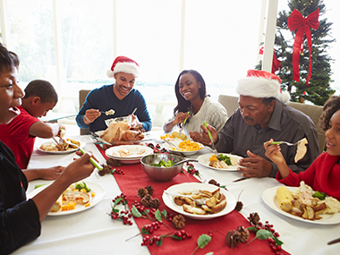family enjoying christmas dinner with enough for leftovers