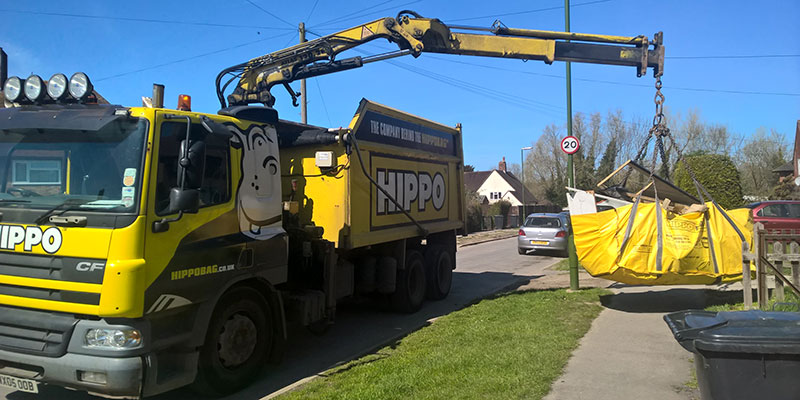 A HIPPO Waste vehicle collecting a HIPPOBAG from a garden