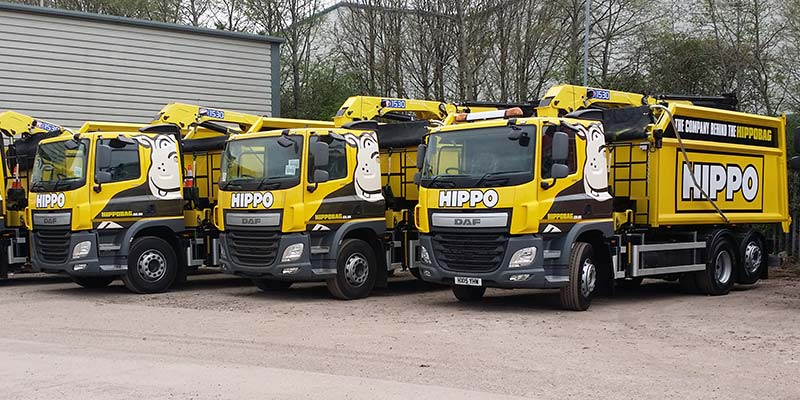 HIPPO vehicles for HIPPOBAG collection parked in a yard