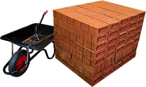 Stack of 500 bricks next to a wheelbarrow for comparison of size showing it is taller