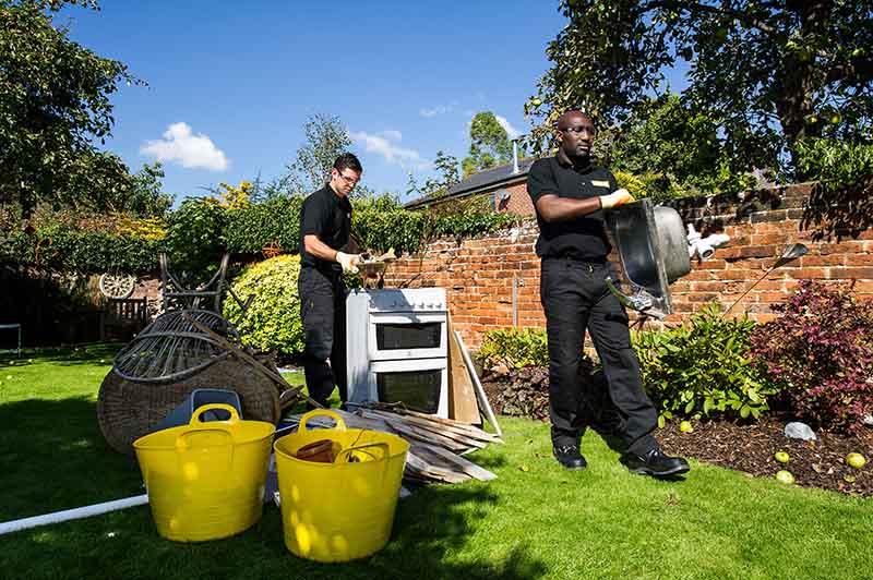 Man and van team clearing rubbish from a garden