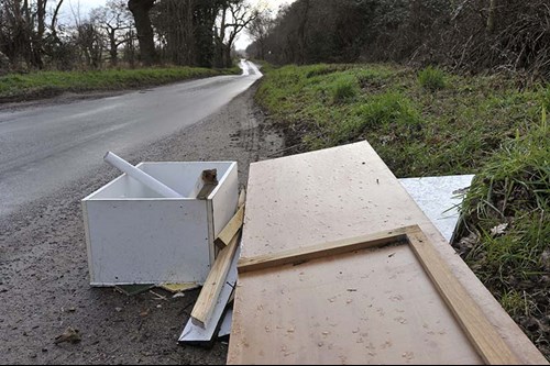 Fly-tipping waste dumped by the side of a country lane