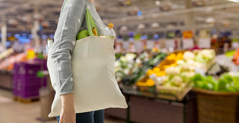 Lady carrying a cotton tote bag in a supermarket