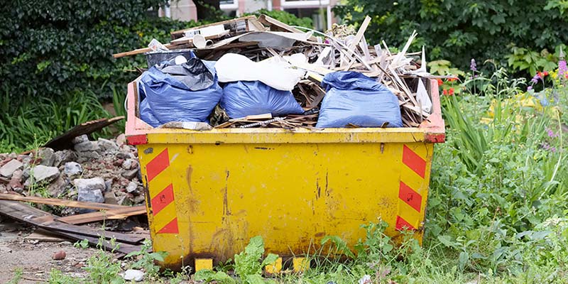 Yellow skip overfilled with waste