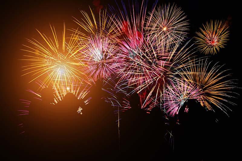 Silhouette of a crowd of people watching a fireworks show