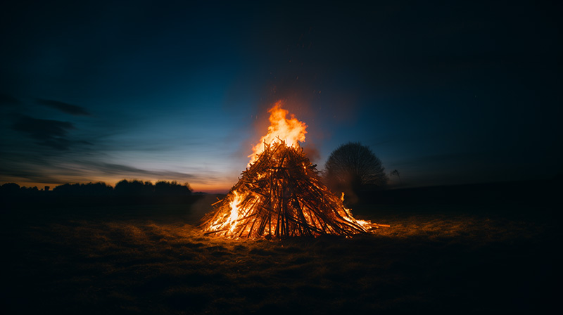 A large bonfire lit in a field