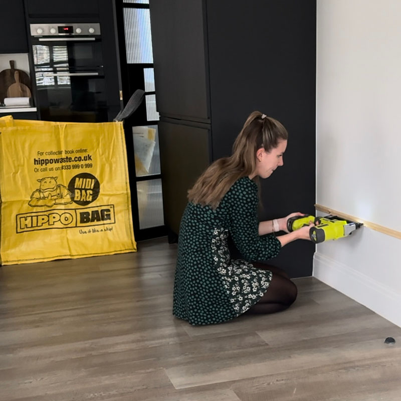 Woman working on DIY project for panelled skirting board