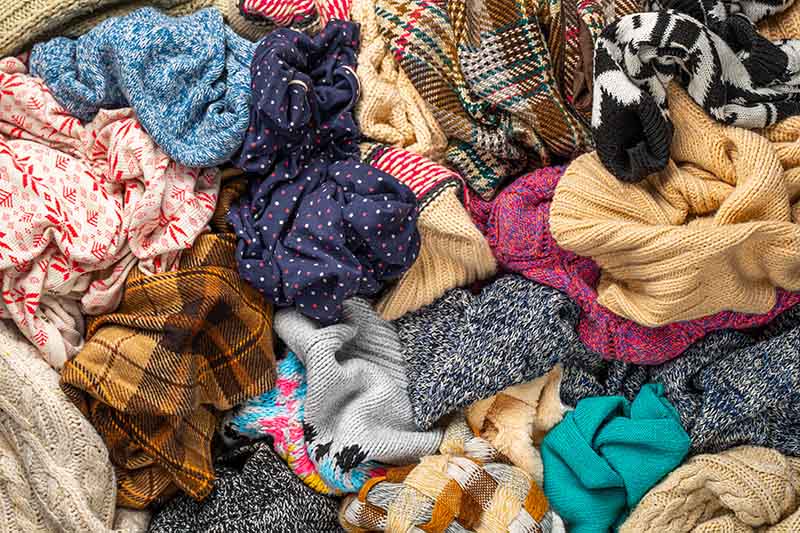 A pile of jumpers and assorted textiles