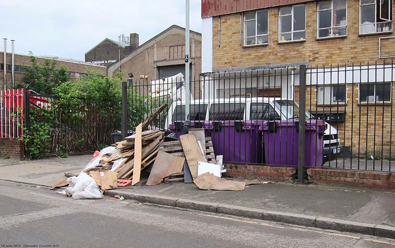 Wood fly-tipped on pavement