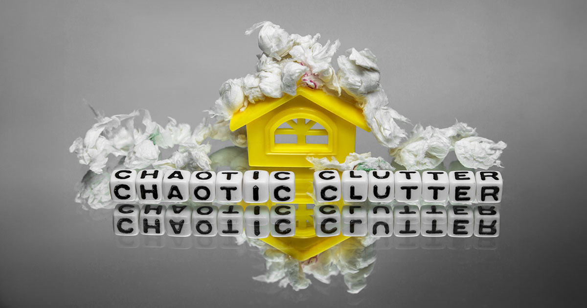 A plastic house with paper depicting that it is cluttered