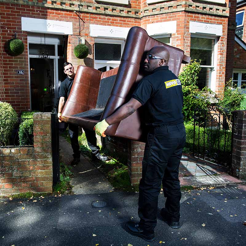 HIPPO Man & Van team carrying a sofa for disposal