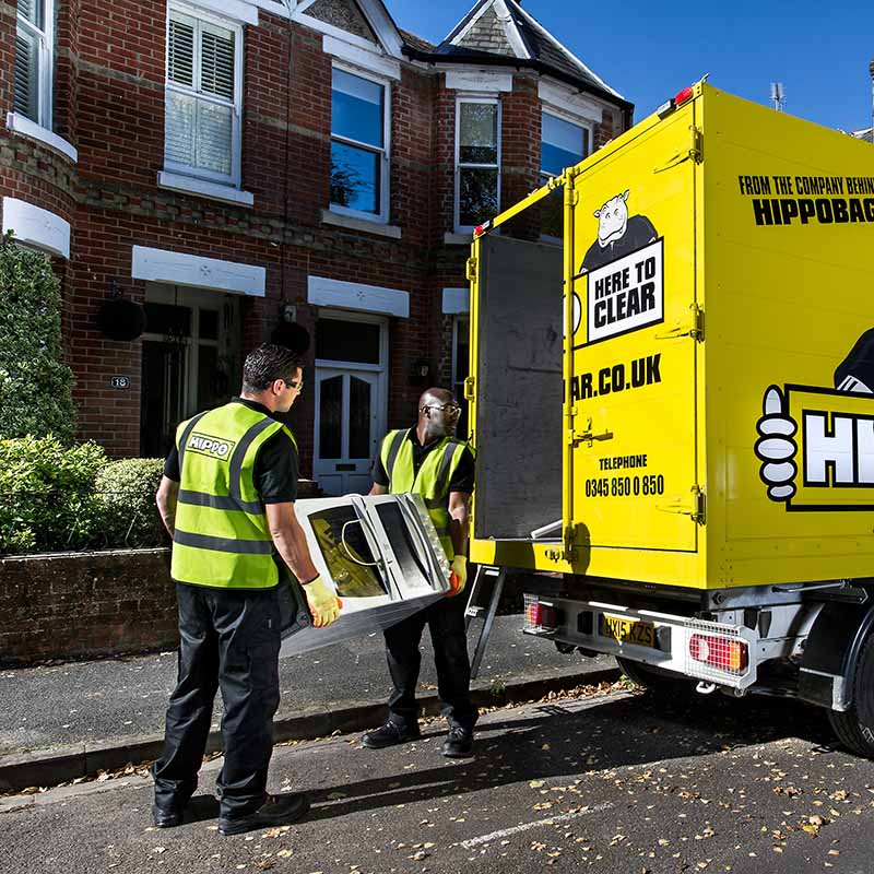 HIPPO Man & Van team loading an oven into a waste collection van