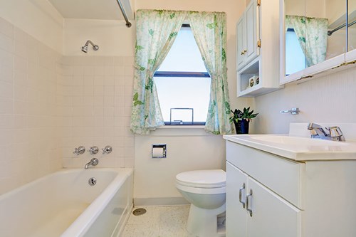 Old style bathroom suite in a plain white bathroom