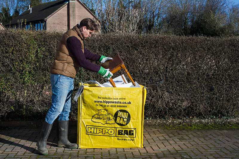 A man filling our smallest HIPPOBAG, a MIDIBAG, on a driveway